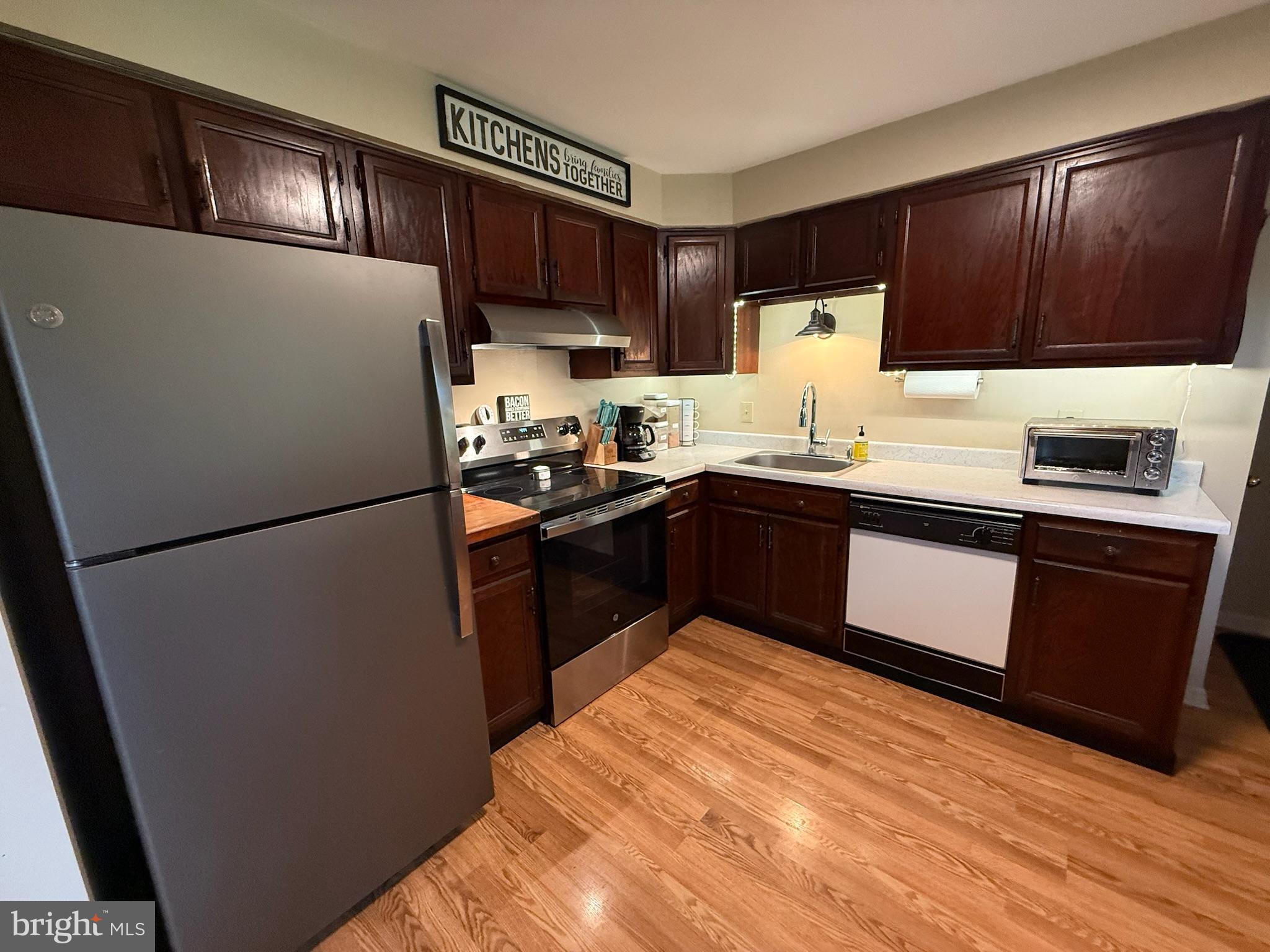 440 Scotland Road Quarryville, PA 17566 - Photo 7 of 35 a kitchen with stainless steel appliances granite countertop a refrigerator a sink dishwasher a stove top oven a refrigerator and cabinets with wooden floor