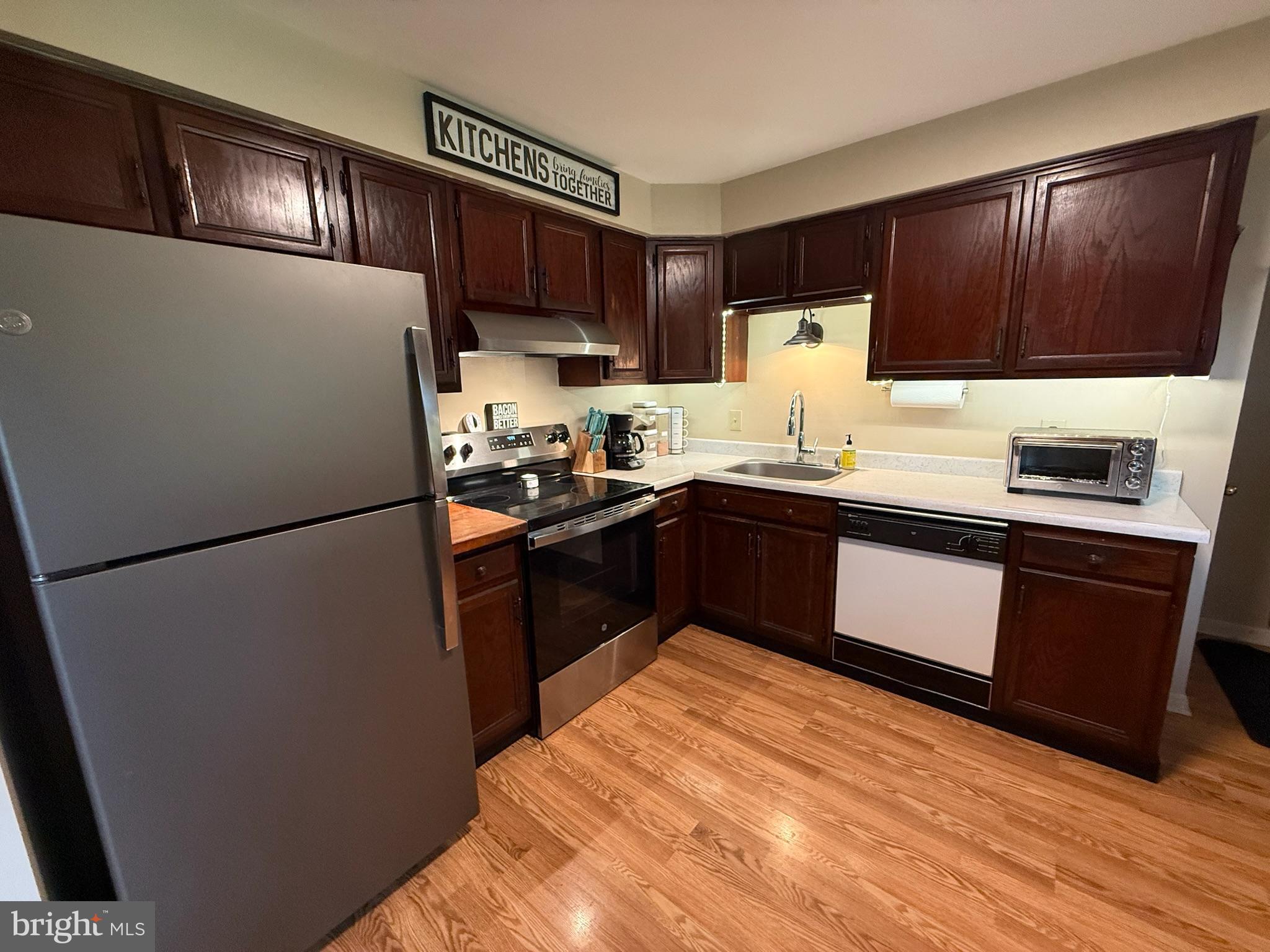 440 Scotland Road Quarryville, PA 17566 - Photo 8 of 35 a kitchen with granite countertop stainless steel appliances a refrigerator a sink and wooden cabinets