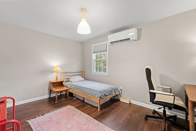 a bedroom with a bed and a desk