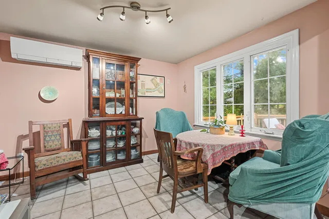 a living room with furniture a flat screen tv and a floor to ceiling window