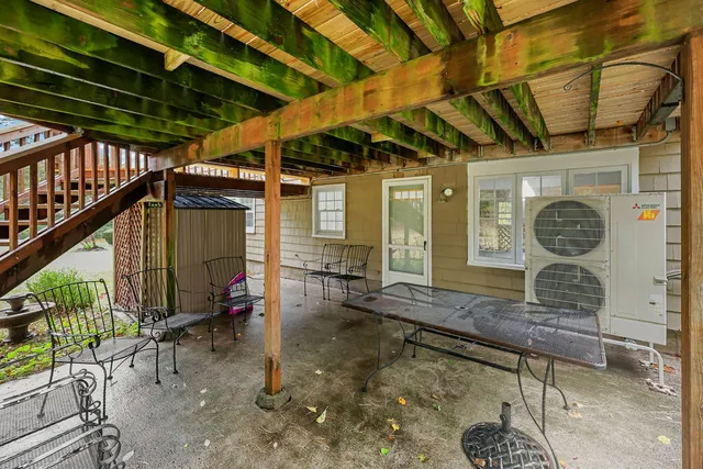 a view of a backyard with a table and chairs