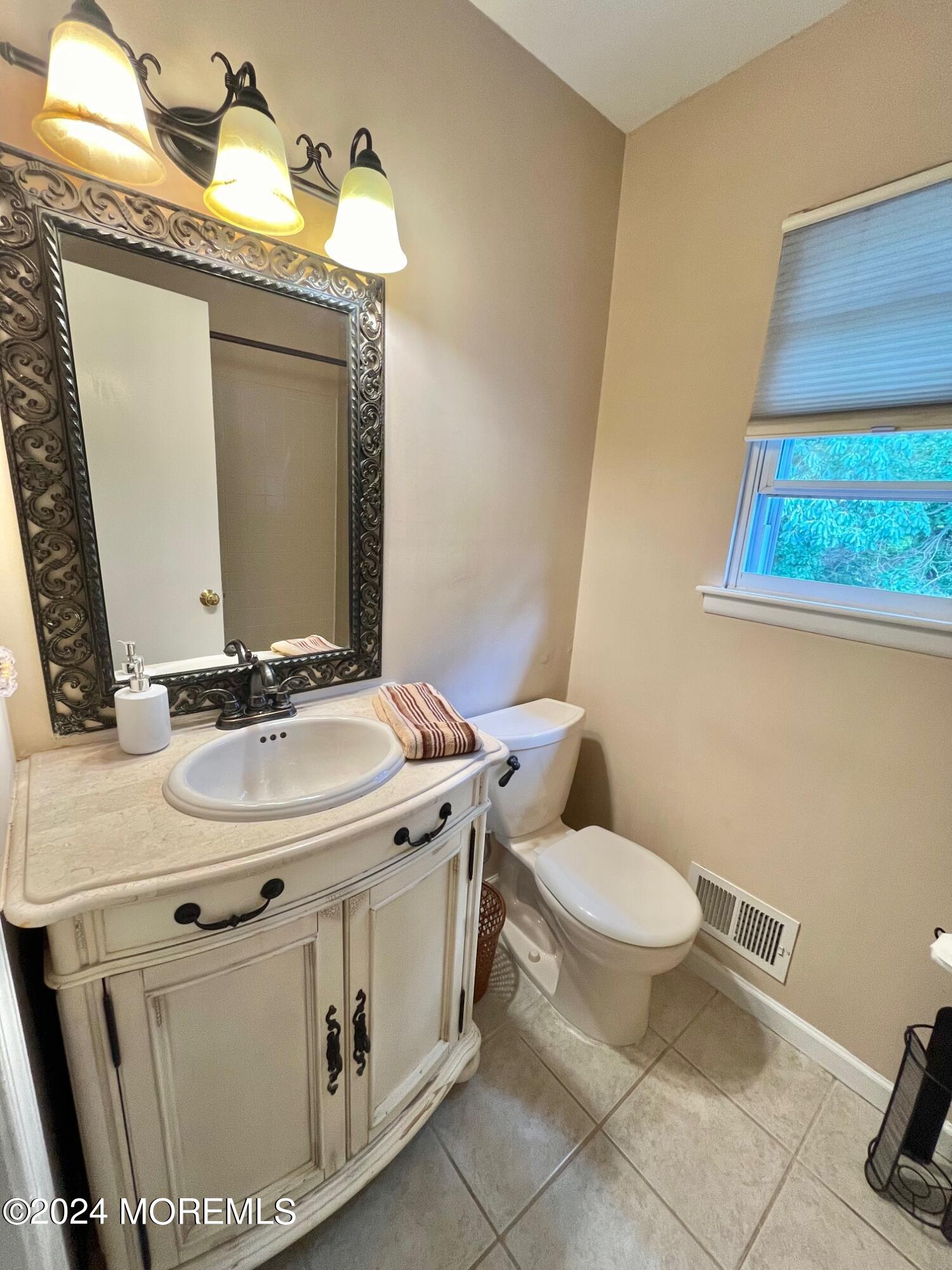 24 Flintlock Drive Howell, NJ 07731 - Photo 11 of 19 a bathroom with a sink toilet and mirror