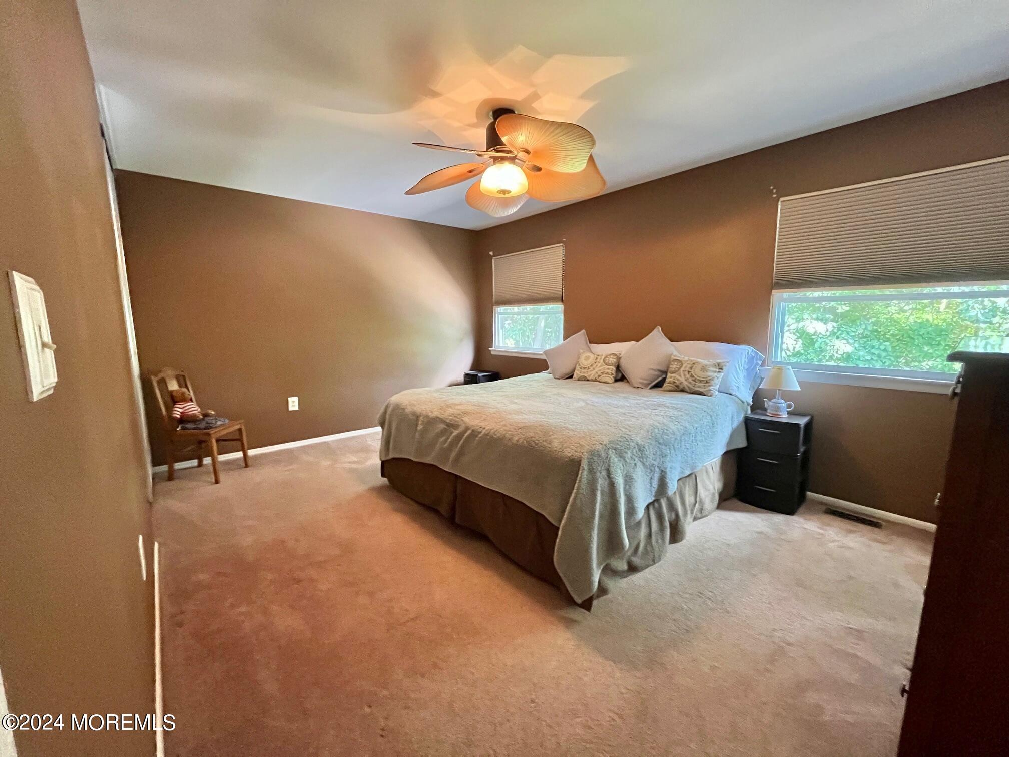 24 Flintlock Drive Howell, NJ 07731 - Photo 13 of 19 a bedroom with a bed and a chandelier