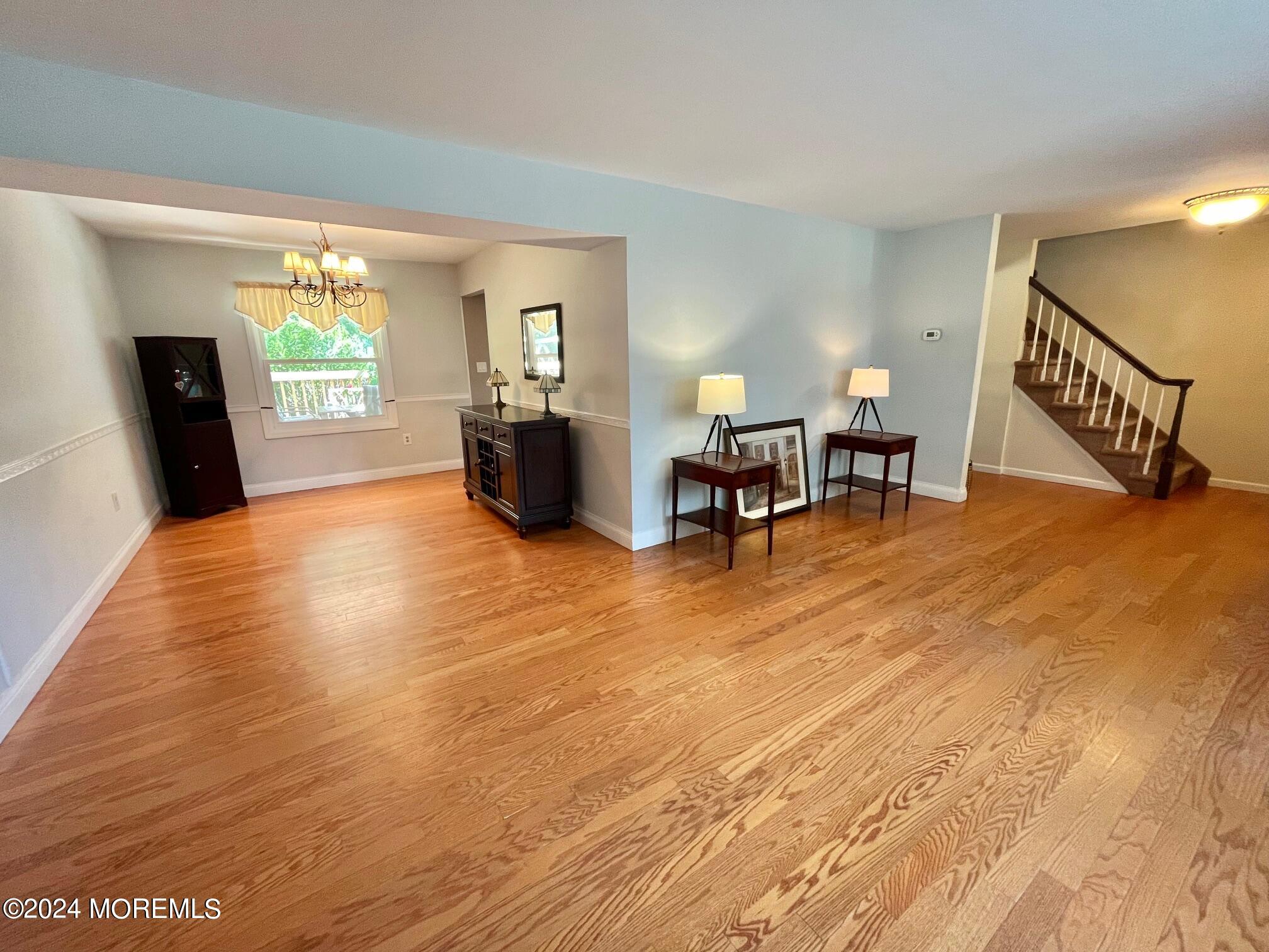 24 Flintlock Drive Howell, NJ 07731 - Photo 2 of 19 a view of an empty room with window and wooden floor