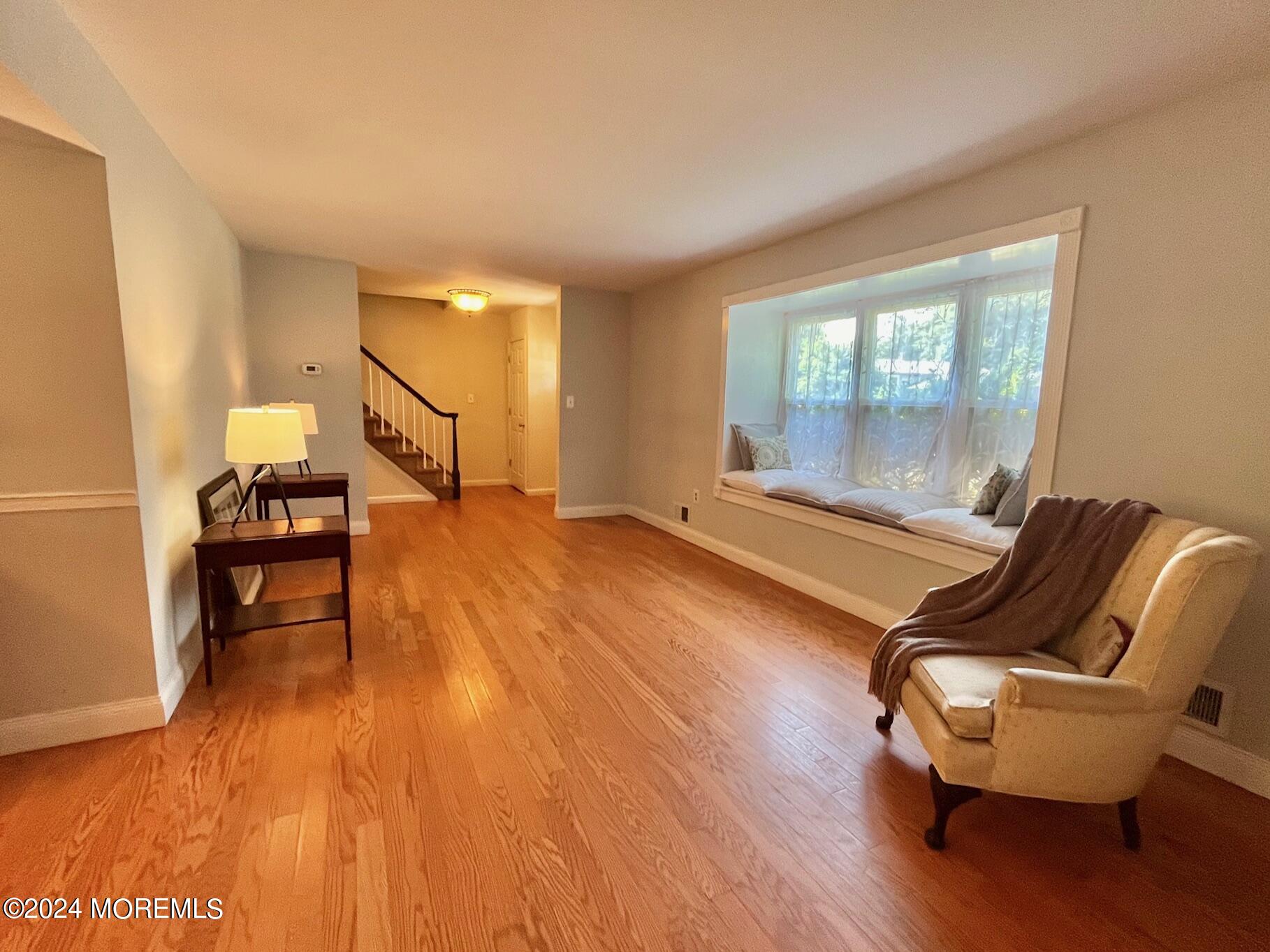 24 Flintlock Drive Howell, NJ 07731 - Photo 3 of 19 a room with wooden floor pool and windows