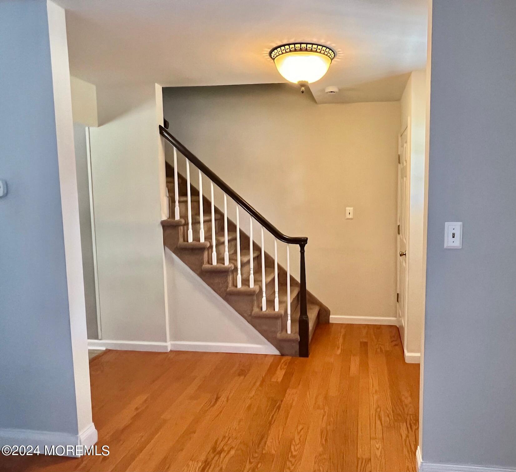 24 Flintlock Drive Howell, NJ 07731 - Photo 5 of 19 a view of a hallway with wooden floor and stairs