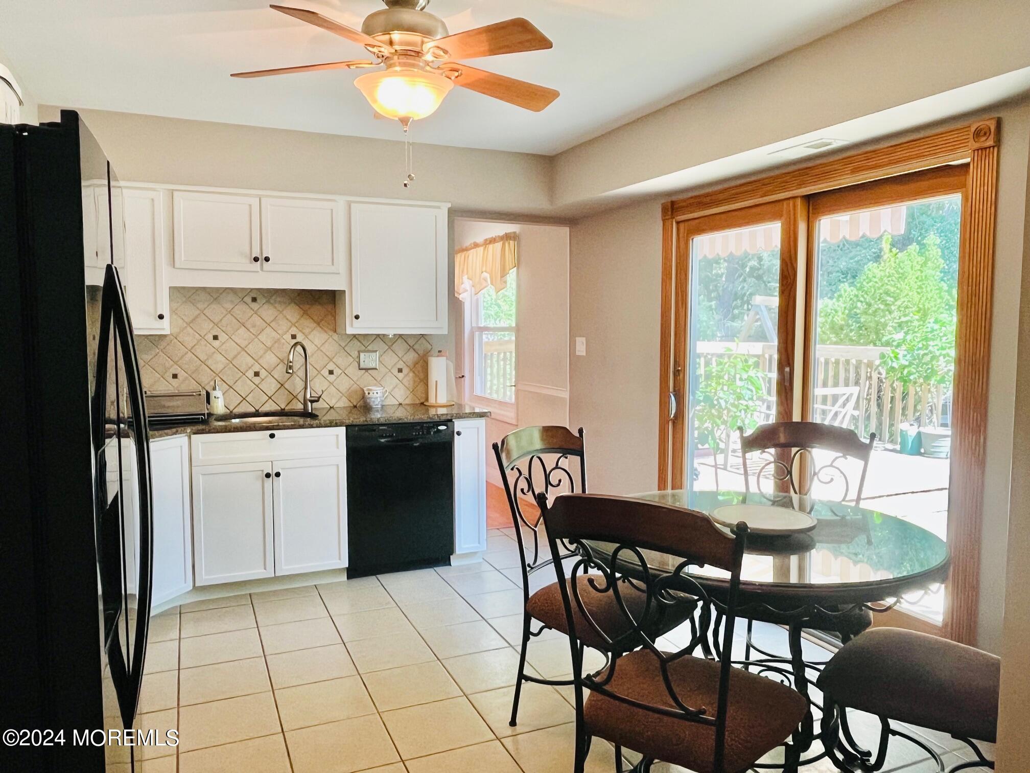 24 Flintlock Drive Howell, NJ 07731 - Photo 6 of 19 a kitchen with a dining table chairs and refrigerator