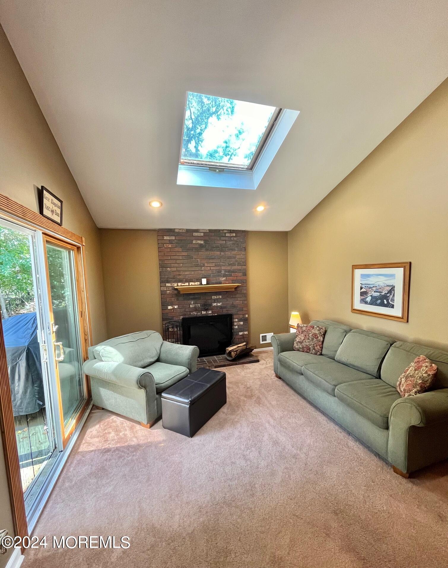24 Flintlock Drive Howell, NJ 07731 - Photo 8 of 19 a living room with furniture a fireplace and a flat screen tv
