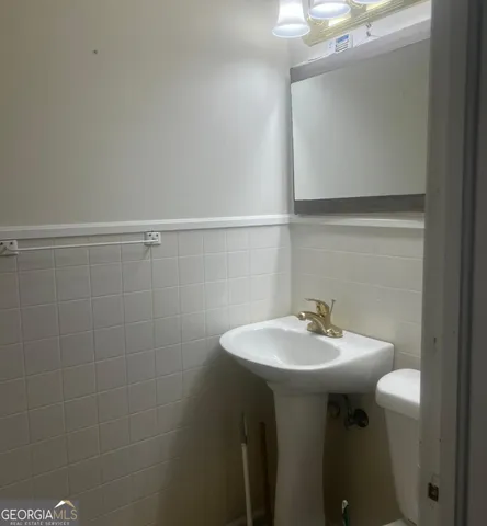 a bathroom with a sink a mirror and a vanity