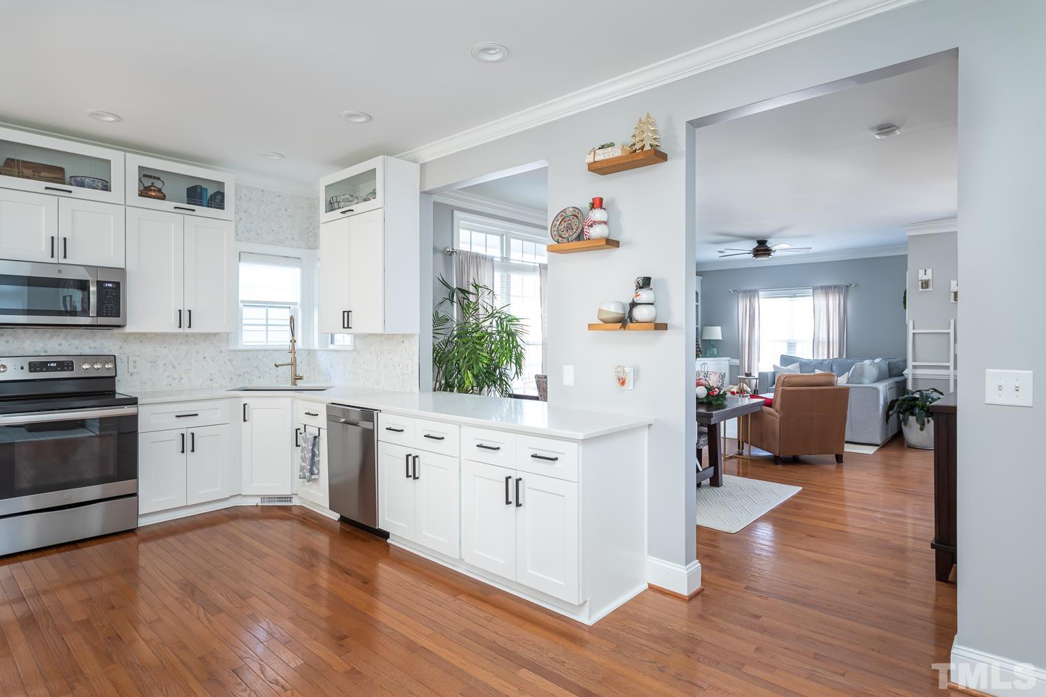 1233 North Blount Street Raleigh, NC 27604 - Photo 11 of 42 a kitchen with a refrigerator and a stove top oven