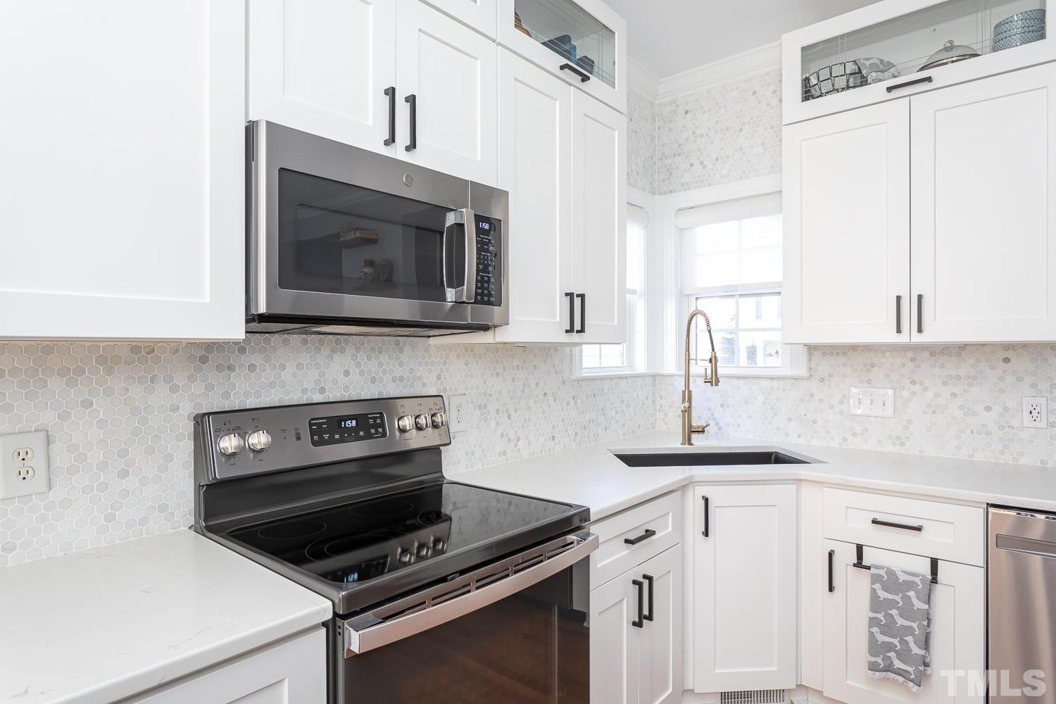 1233 North Blount Street Raleigh, NC 27604 - Photo 12 of 42 a kitchen with cabinets stainless steel appliances and a sink