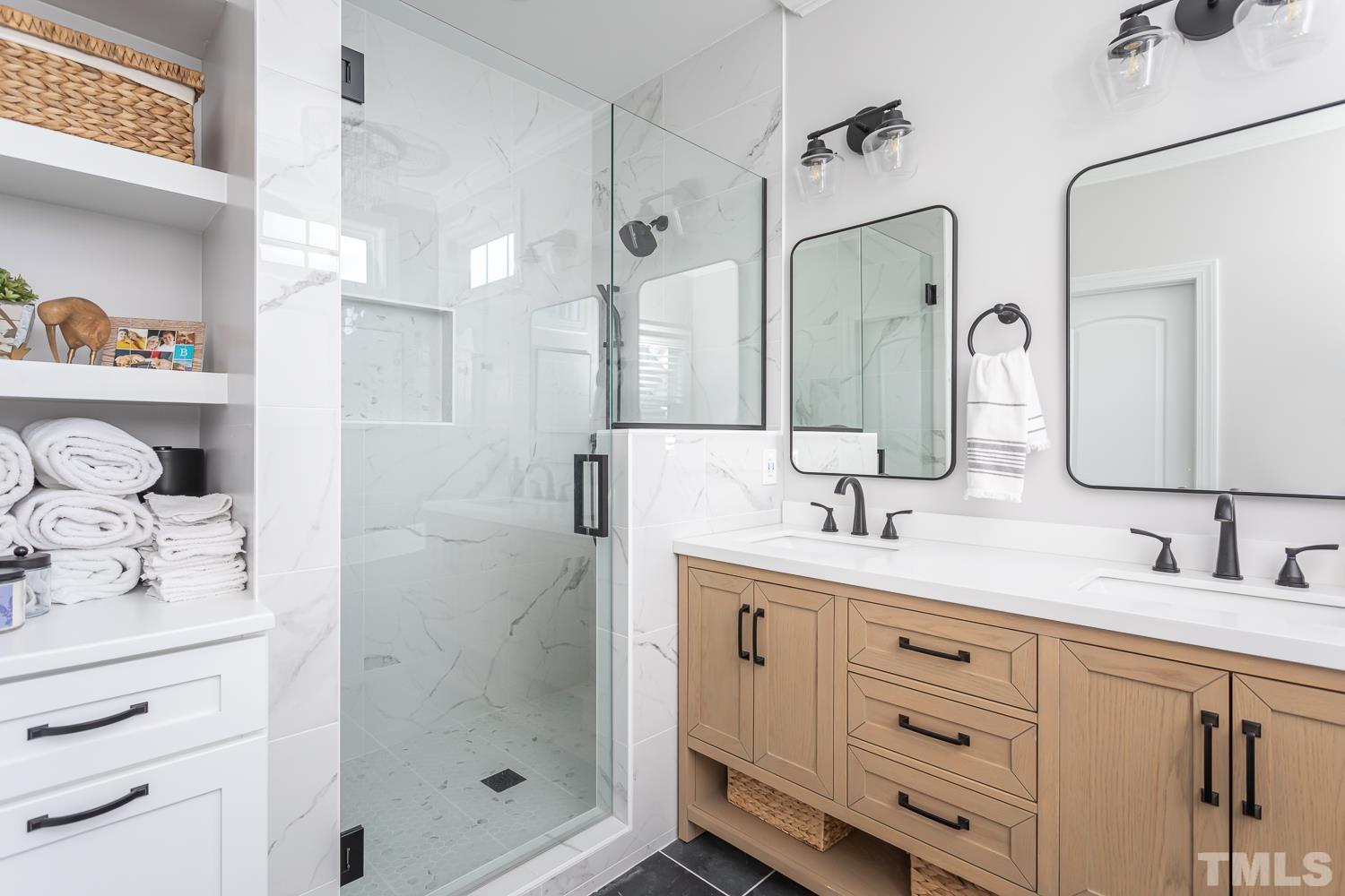 1233 North Blount Street Raleigh, NC 27604 - Photo 23 of 42 a bathroom with a shower sink and mirror