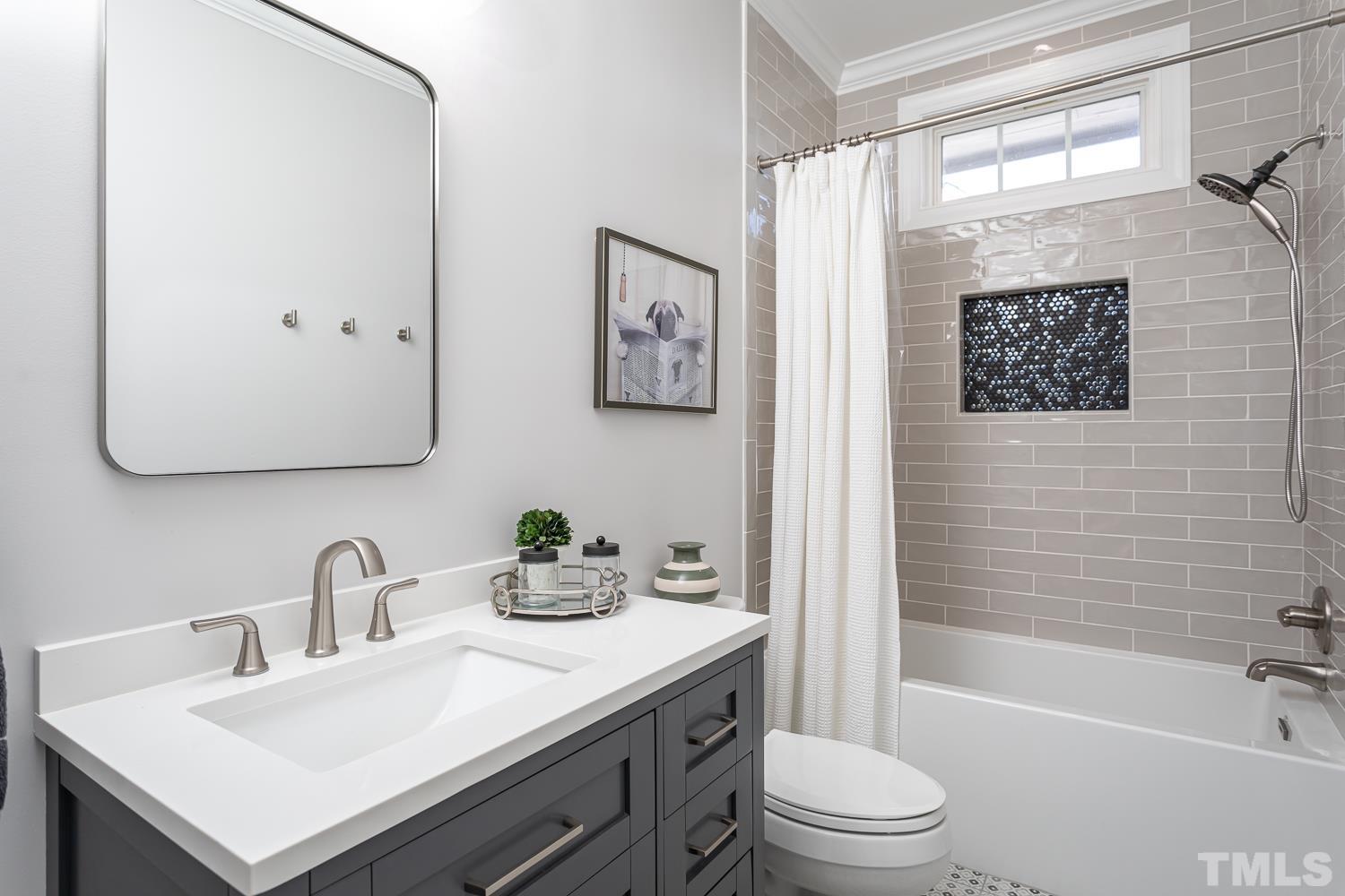 1233 North Blount Street Raleigh, NC 27604 - Photo 25 of 42 a bathroom with a sink a toilet and a bathtub