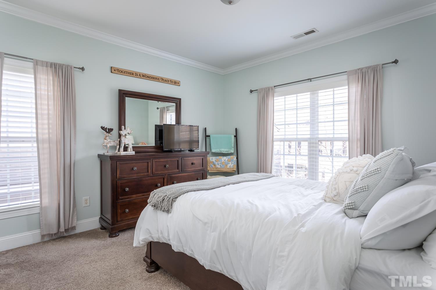 1233 North Blount Street Raleigh, NC 27604 - Photo 26 of 42 a bedroom with a bed and a flat tv screen on dresser