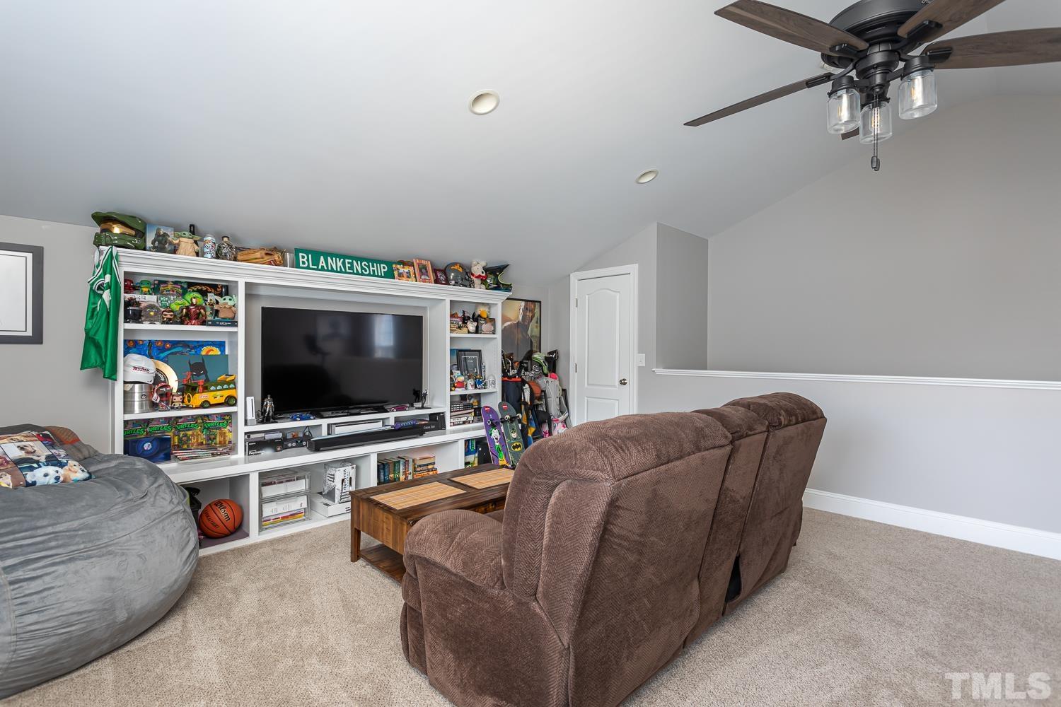 1233 North Blount Street Raleigh, NC 27604 - Photo 30 of 42 a living room with furniture and a flat screen tv