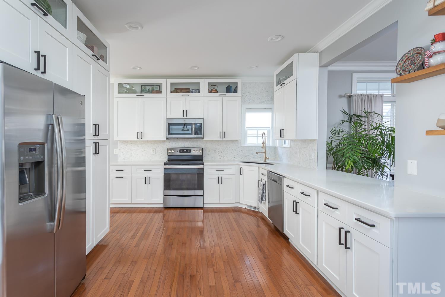 1233 North Blount Street Raleigh, NC 27604 - Photo 10 of 42 a kitchen with stainless steel appliances a refrigerator sink and wooden floor