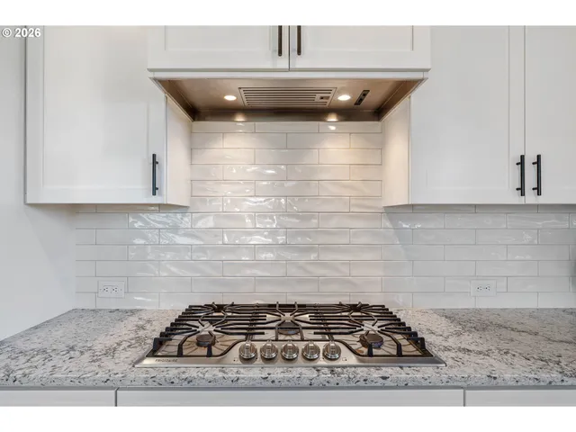 a kitchen with a stove and a cabinets