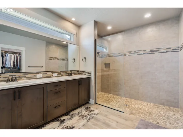 a bathroom with a sink a toilet a shower and a mirror