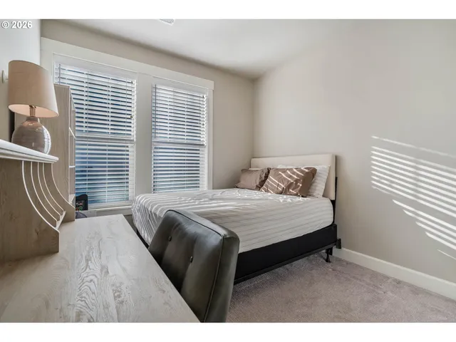 a bedroom with a bed and a night stand