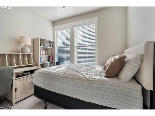 a bedroom with a bed and a window