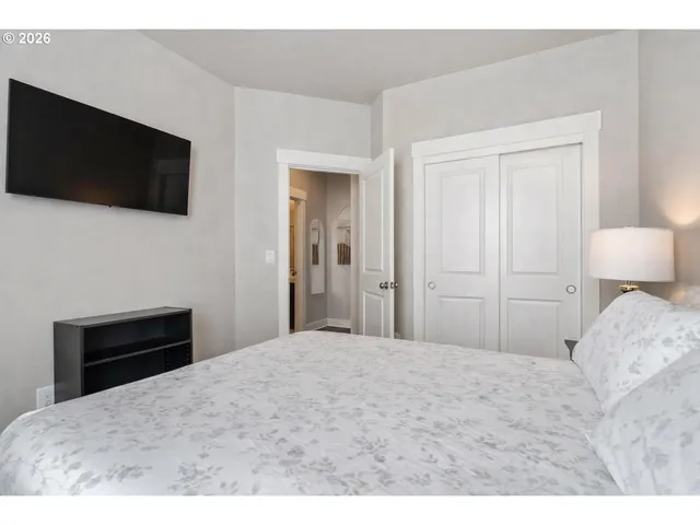 a bedroom with a bed and a flat screen tv