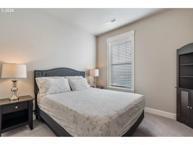 a bedroom with a bed and a night stand