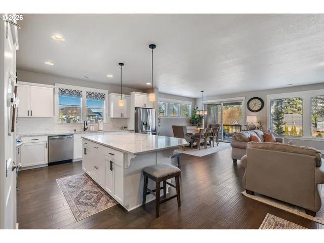 a large white kitchen with lots of counter space a sink and appliances