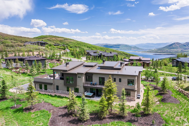 140 West Vista Road Kamas, UT 84036 - Photo 97 of 101 Modern multi-level exterior with extensive windows, multiple balconies, a ground-level patio, and an integrated hot tub