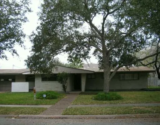 a front view of a house with a yard and a garage