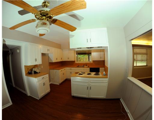 409 Barracuda Place Corpus Christi, TX 78411 - Photo 4 of 10 a room with stainless steel appliances a stove a refrigerator and cabinets