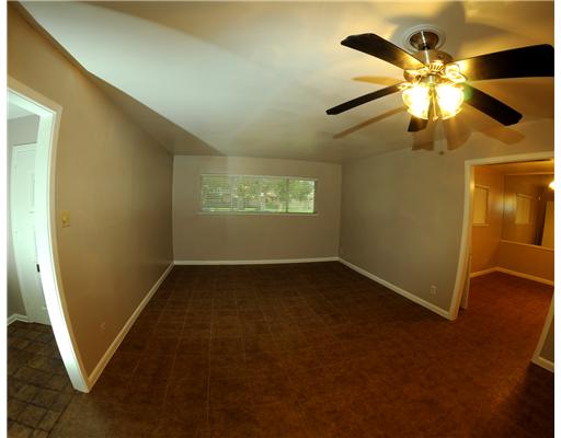 409 Barracuda Place Corpus Christi, TX 78411 - Photo 6 of 10 an empty room with windows and fan