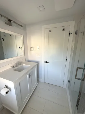 a bathroom with a double vanity sink and mirror