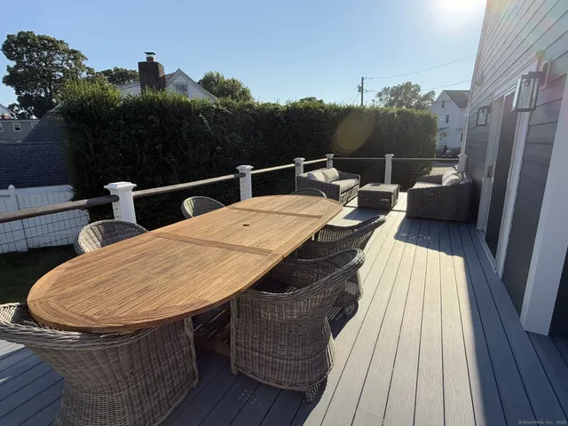 a view of a chairs and tables on the balcony