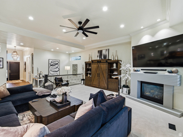1154 Sunset Dunes Way Draper, UT 84020 - Photo 12 of 50 Living area featuring a glass covered fireplace, a ceiling fan, ornamental molding, and recessed lighting