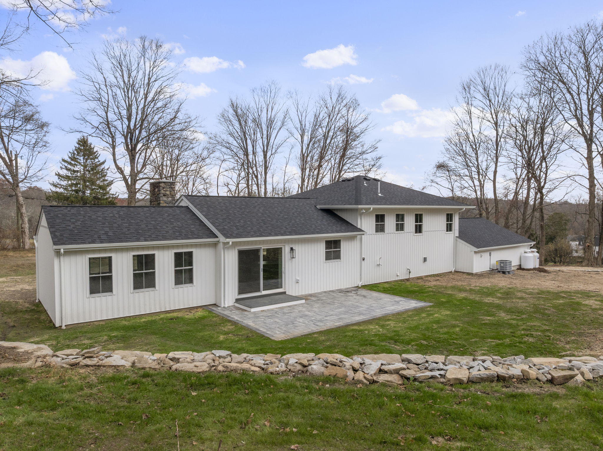 52 Curtis Road Bridgewater, CT 06752 - Photo 19 of 25 A private, spacious backyard designed for play, gardening, or unwinding, featuring a beautiful patio perfect for dining al fresco or relaxing outdoors. Also, hot tub ready for the ultimate retreat.