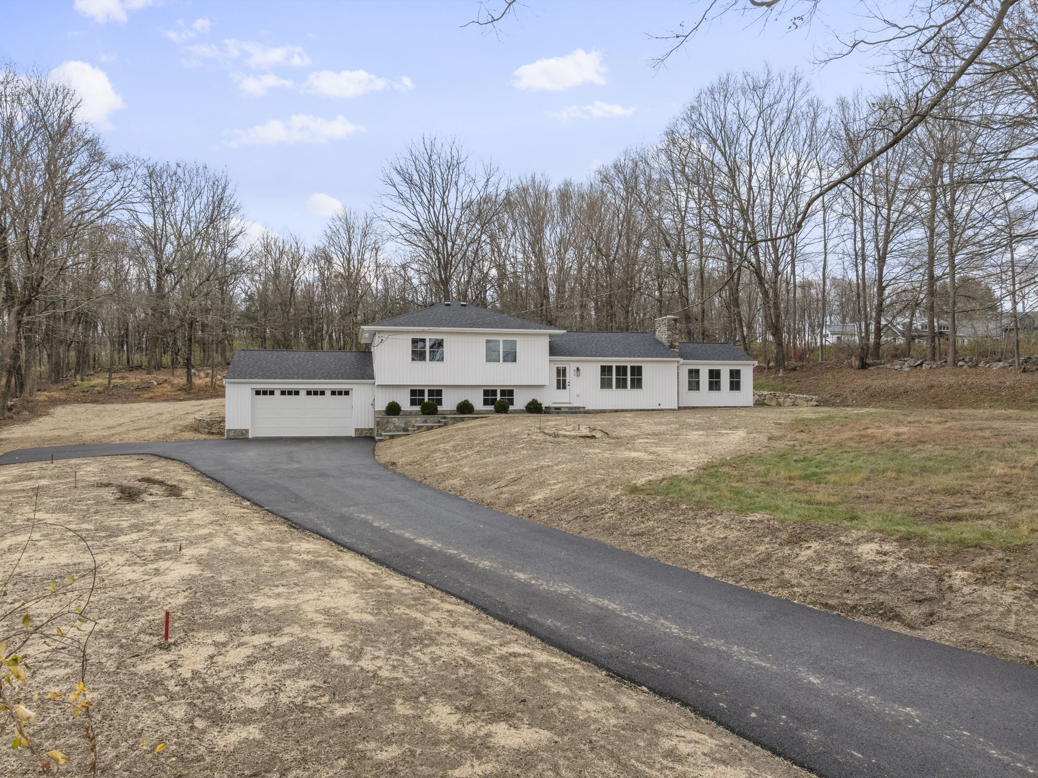 52 Curtis Road Bridgewater, CT 06752 - Photo 24 of 25 Set on 1.34 acres with wooded views, this modern farmhouse split features a new roof, siding, windows and driveway. Thoughtfully designed 2-car addition and versatile living space off the kitchen and lower-level offering comfort and versatility.