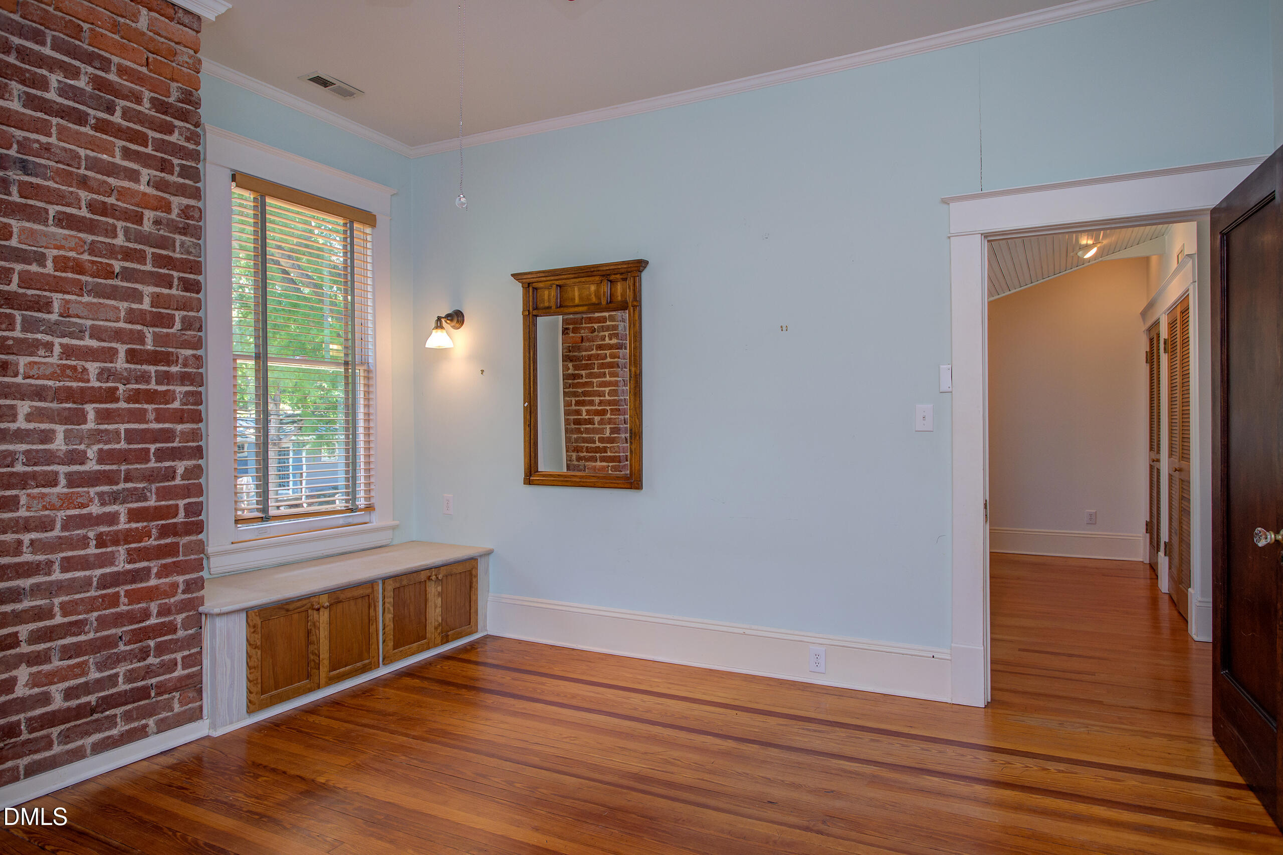 127 Forest Road Raleigh, NC 27605 - Photo 55 of 75 a view of an empty room with wooden floor and a window