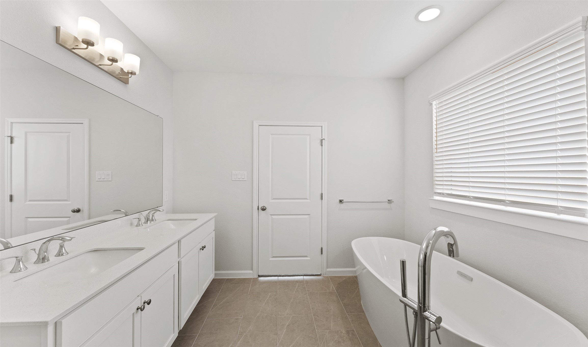 29306 Suncreek Rnch Court Waller, TX 77484 - Photo 8 of 27 a bathroom with a double vanity sink a mirror and a bathtub