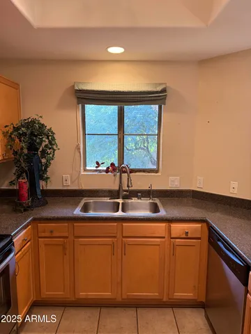 a kitchen with cabinets and window