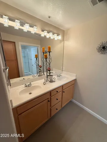 a bathroom with a double vanity sink and a mirror