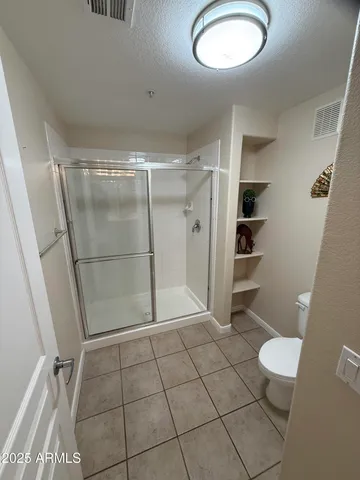 a bathroom with a shower and toilet