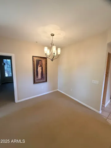 an empty room with a view of a house