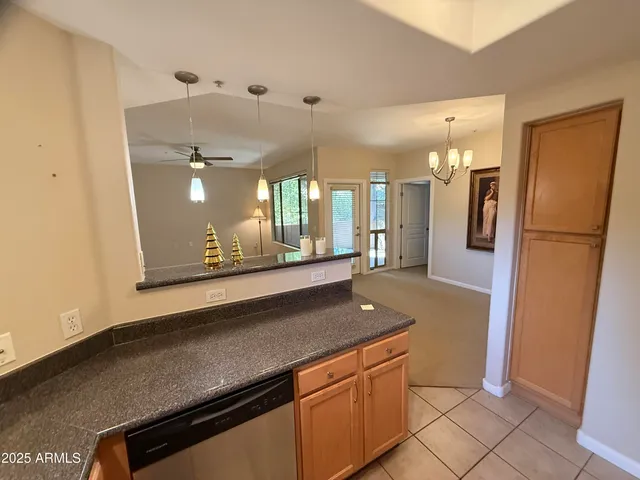 a view of a refrigerator a sink dishwasher and a refrigerator in a kitchen