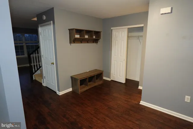 a view of a livingroom with wooden floor and a flat screen tv