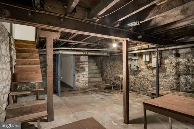 a view of a big room with wooden floor and windows