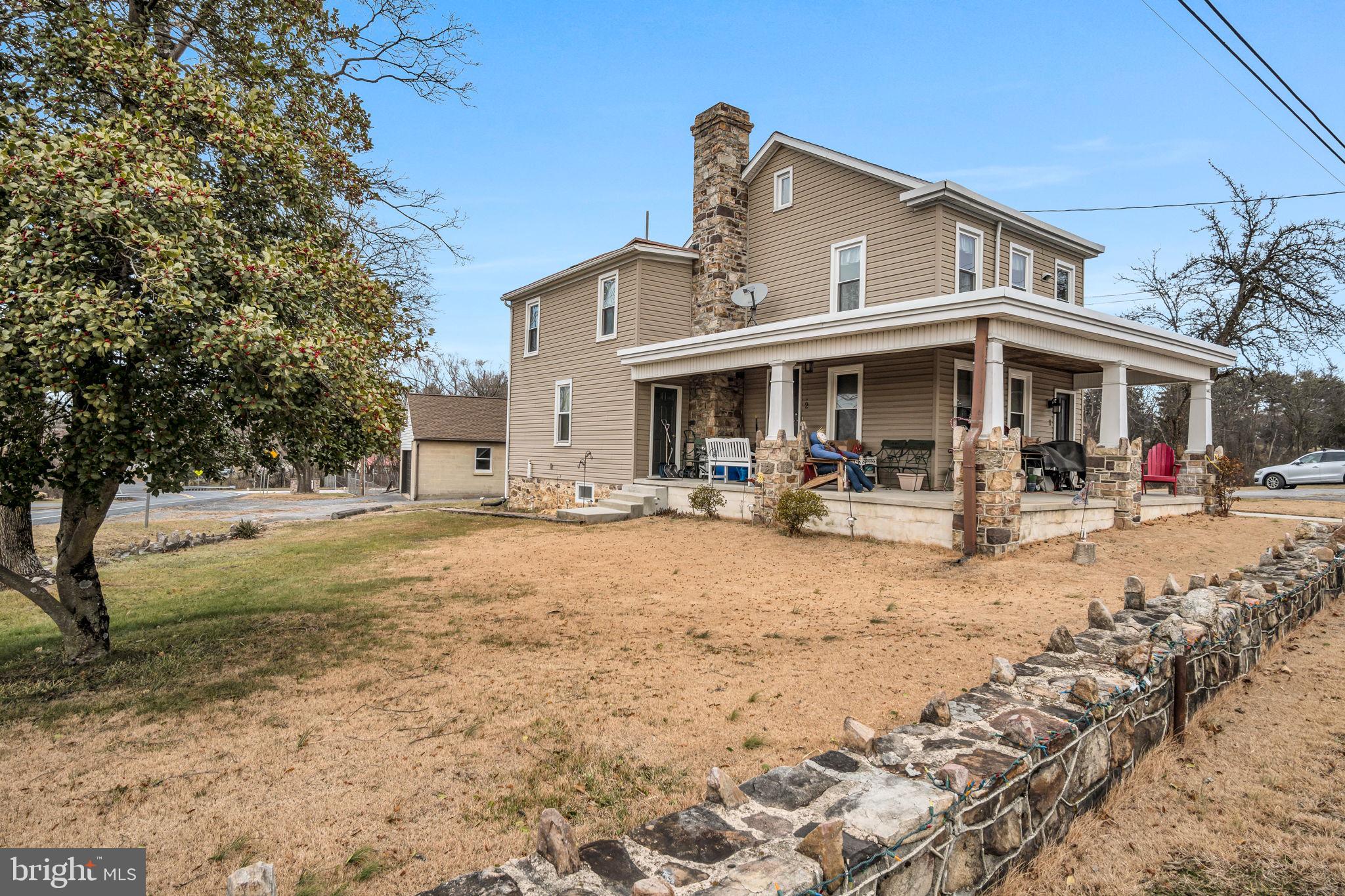 1602 Spring Road Carlisle, PA 17013 - Photo 8 of 33 a view of a white house with a big yard and large trees