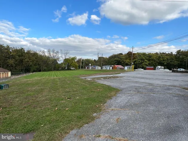 a view of grassy field with mountain
