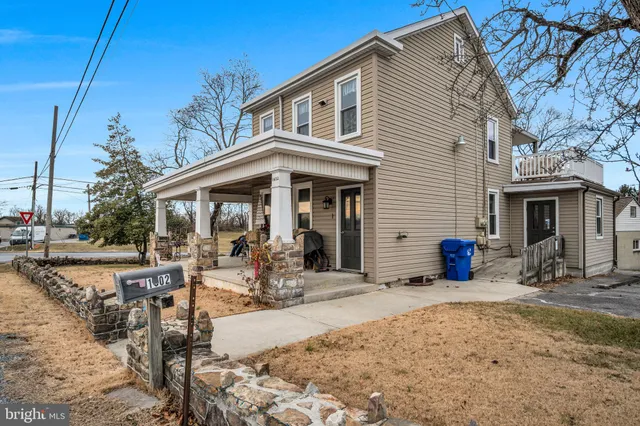 a front view of house with outdoor seating