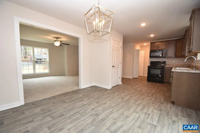 a view of a kitchen with furniture and wooden floor