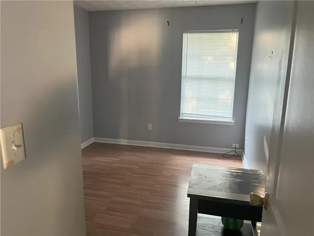 a view of room with window and wooden floor
